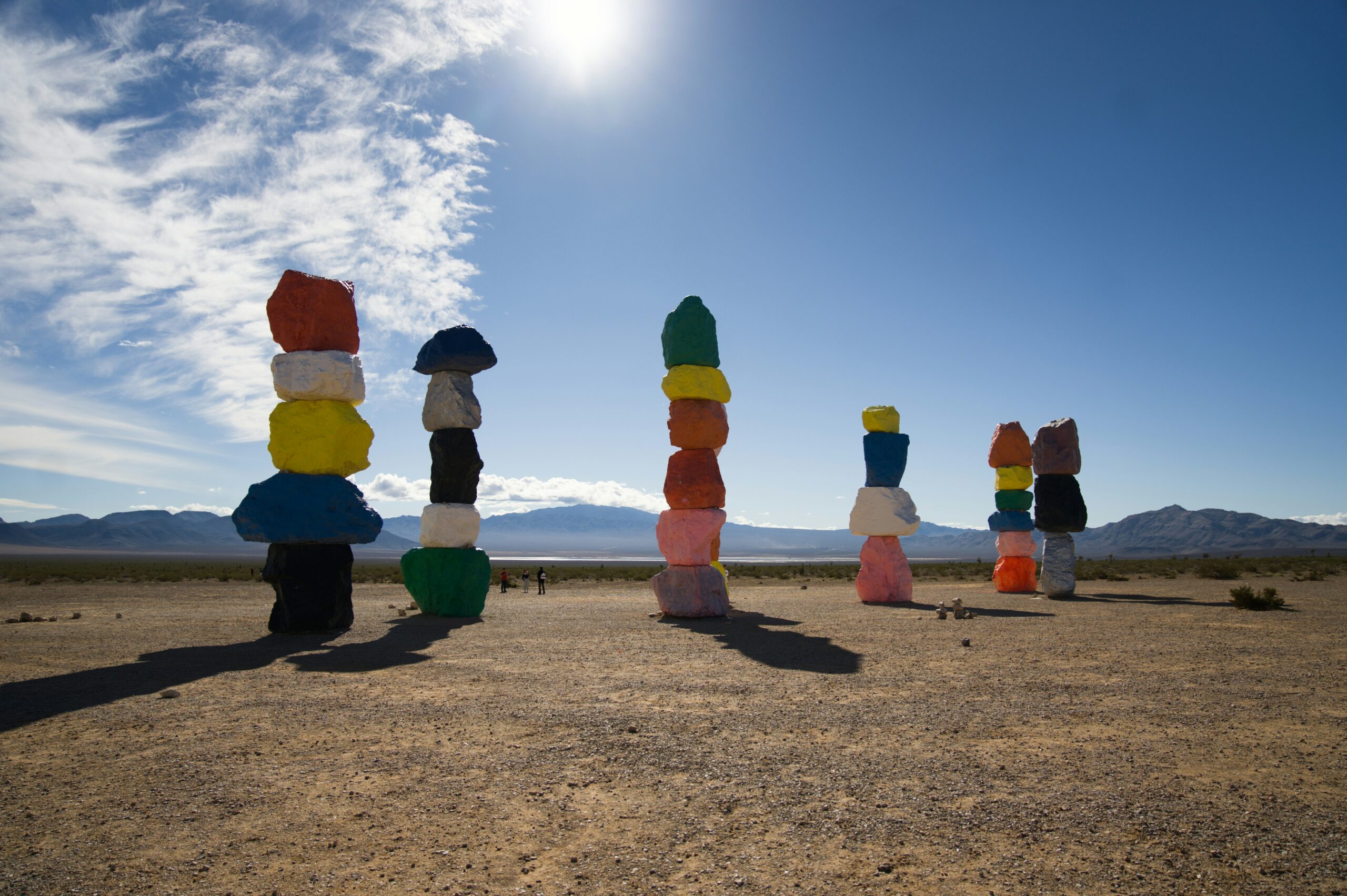 Colorful stacked stones in the desert representing PH Med stacking aesthetic treatments for compounding results